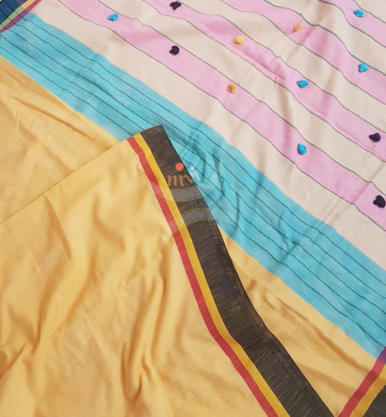 Yellow handloom cotton with contrasting black border, pompoms on pallu and running blouse.