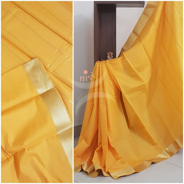Yellow cotton blend with subtle zari border and striped pallu.