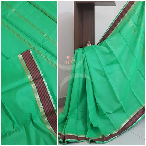 Green cotton blend with contrasting maroon border and striped pallu.