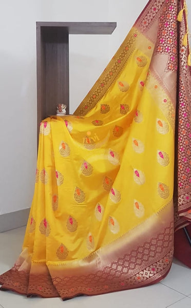 Yellow dupion art silk brocade saree with contrast border and pallu.