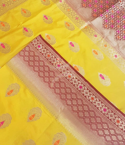 Yellow dupion art silk brocade saree with contrast border and pallu.