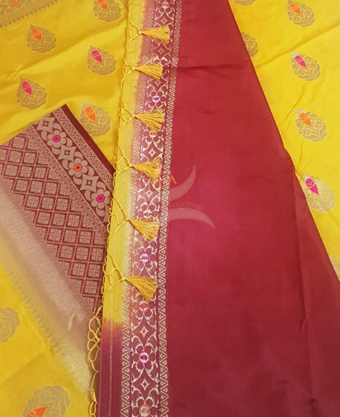 Yellow dupion art silk brocade saree with contrast border and pallu.