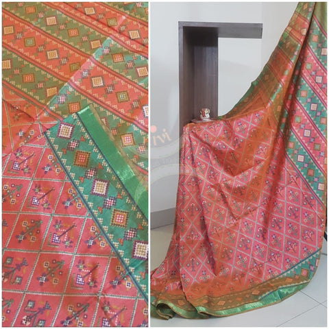 Orange red Patola art silk printed saree with contrast blouse piece and tissue border