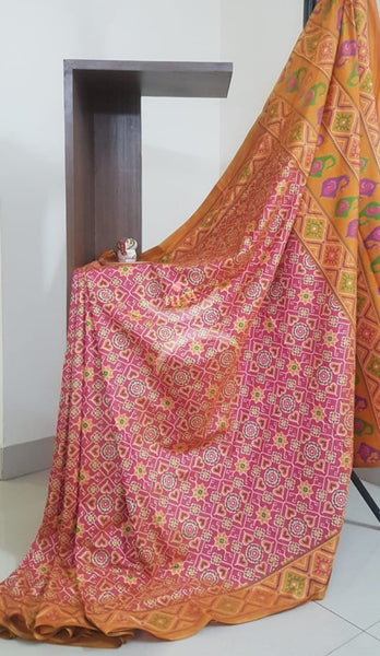 Peachish pink Patola art silk printed saree with contrast blouse piece.