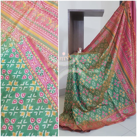 Green Patola art silk printed saree with contrast blouse piece.