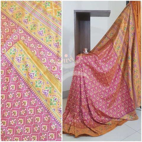 Peachish pink Patola art silk printed saree with contrast blouse piece.