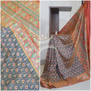 Grey Patola art silk printed saree with contrast blouse piece.