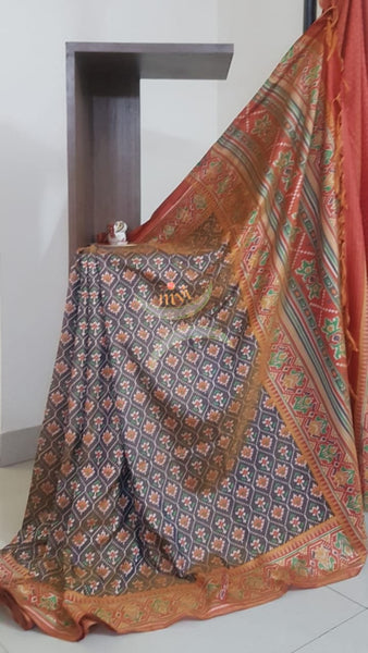 Grey Patola art silk printed saree with contrast blouse piece.