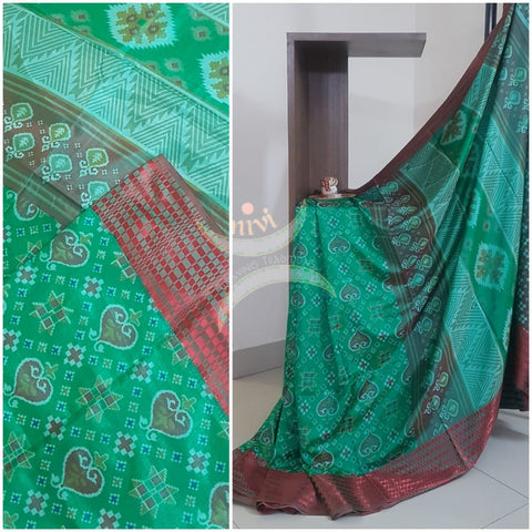 Green Patola art silk printed saree with contrast blouse piece.