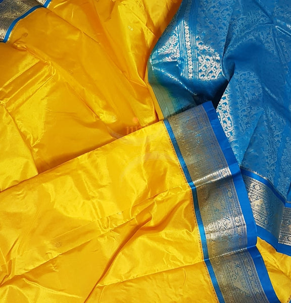 Yellow with blue handloom small Ghatti border pure south silk saree.