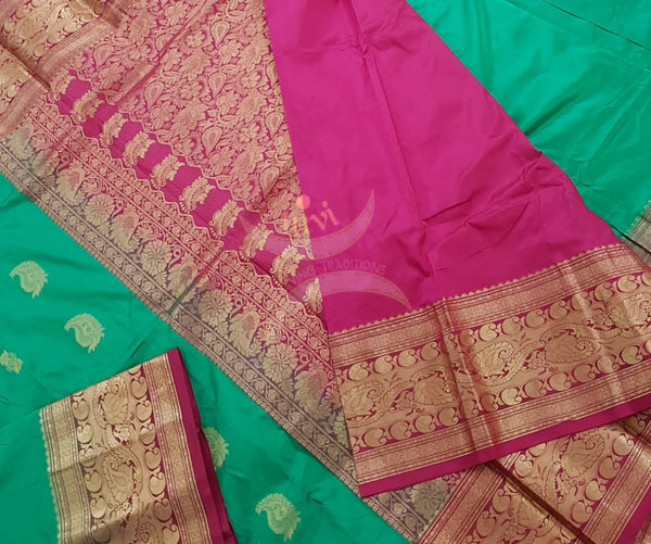 Sea green with red pure south silk saree woven with paisley and floral brocade pattern on pallu, border and has paisley and floral booties all over.