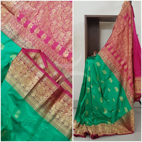 Sea green with red pure south silk saree woven with paisley and floral brocade pattern on pallu, border and has paisley and floral booties all over.