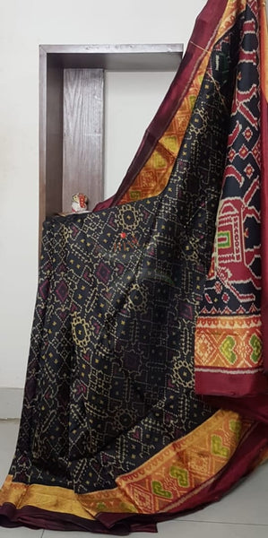 Black Handloom patan patola silk saree with intricate woven pattern and subtle gold zari.