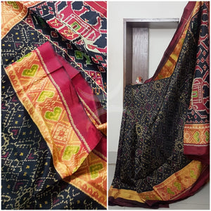 Black Handloom patan patola silk saree with intricate woven pattern and subtle gold zari.