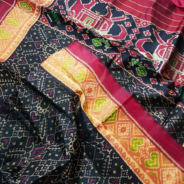 Black Handloom patan patola silk saree with intricate woven pattern and subtle gold zari.