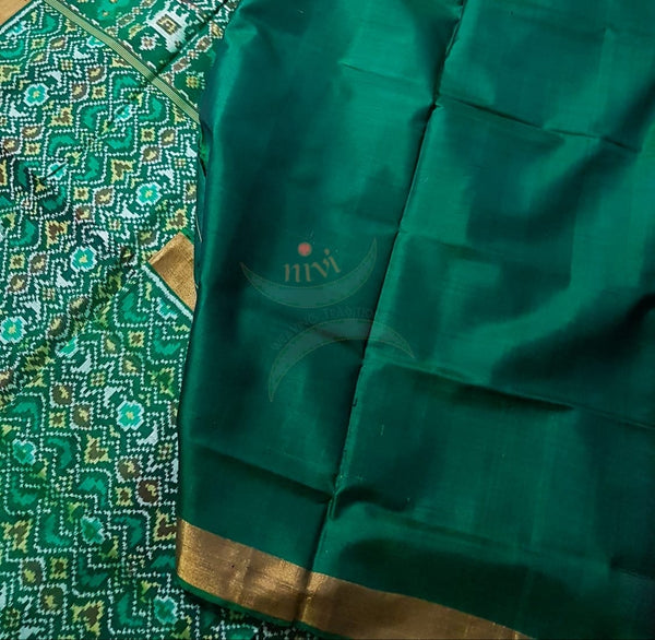 Teal Green Handloom patan patola silk saree with intricate woven pattern and subtle gold zari.