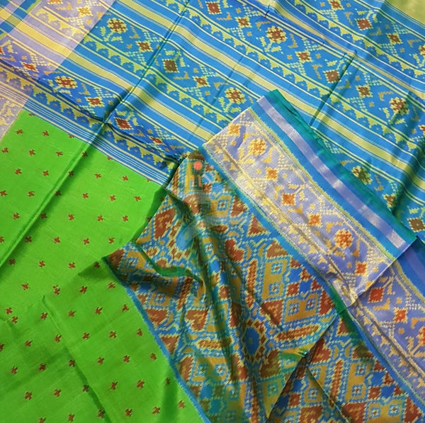 Green Handloom patan patola silk saree with intricate woven pattern and subtle gold zari.