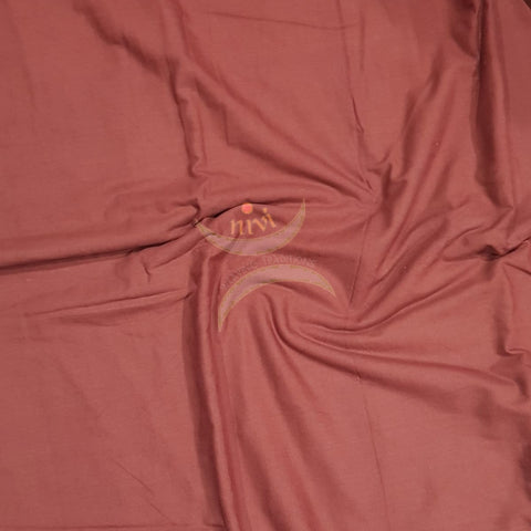Brick red handloom mercerised cotton fabric.
