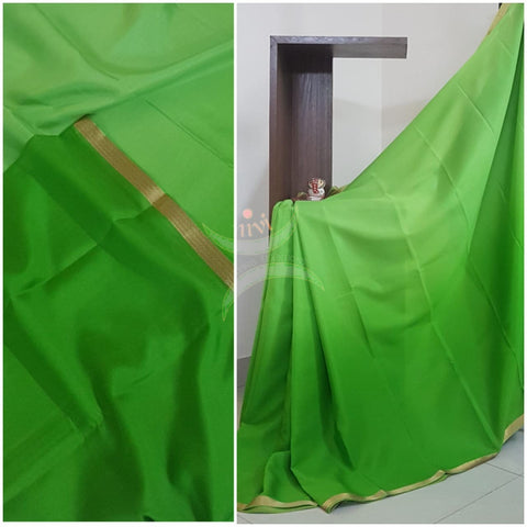 50 gms Two Tone pure Silk Crepe in shades of Green with a fine zari border. Saree comes with pure Green crepe blouse in darker tone.