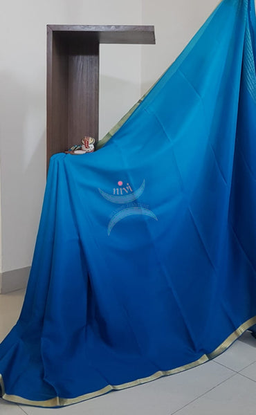 50 gms Two Tone pure Silk Crepe in shades of blue with a fine zari border. Saree comes with pure blue crepe blouse in darker tone.