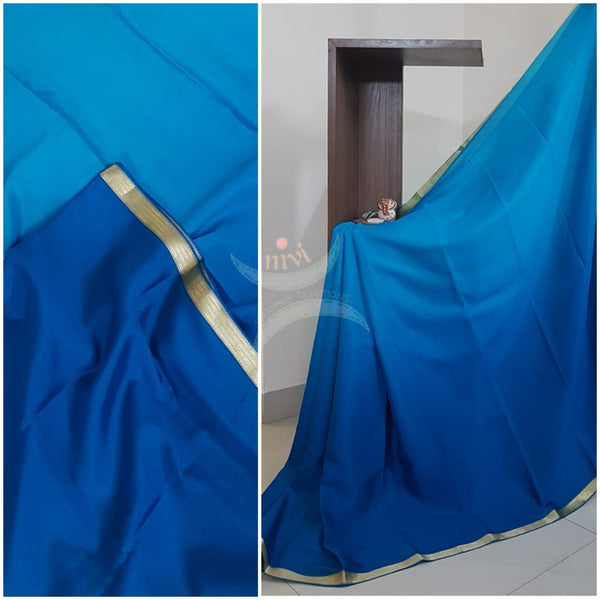 50 gms Two Tone pure Silk Crepe in shades of blue with a fine zari border. Saree comes with pure blue crepe blouse in darker tone.
