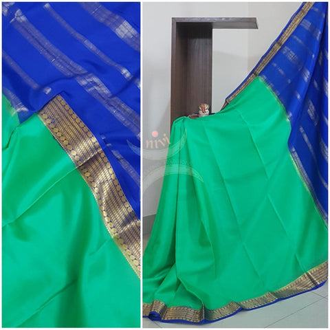 Sea Green with blue 50 grams pure mysore silk crepe with traditional border and striped pallu. Saree comes with plain blue blouse matching pallu.