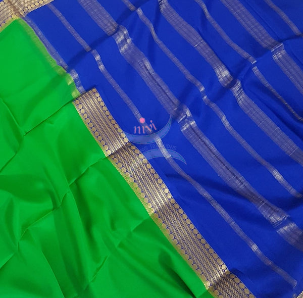 Green with royal blue 50 grams pure mysore silk crepe with traditional border and striped pallu. Saree comes with plain royal blue blouse matching pallu.
