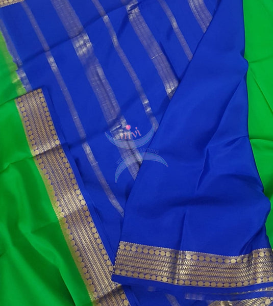 Green with royal blue 50 grams pure mysore silk crepe with traditional border and striped pallu. Saree comes with plain royal blue blouse matching pallu.