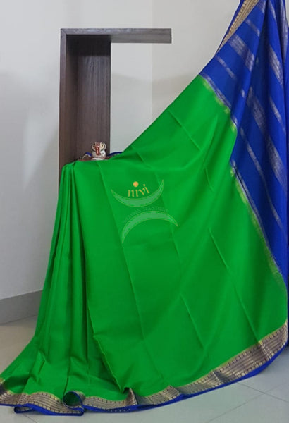 Green with royal blue 50 grams pure mysore silk crepe with traditional border and striped pallu. Saree comes with plain royal blue blouse matching pallu.