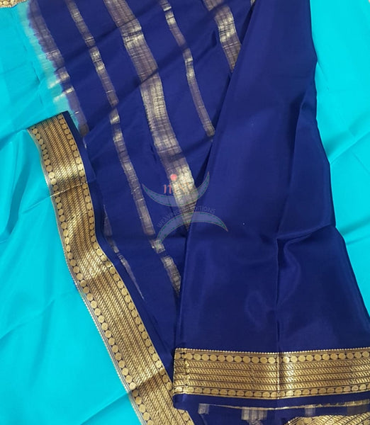 Blue with Navy blue 50 grams pure mysore silk crepe with traditional border and striped pallu. Saree comes with plain navy blue blouse matching pallu.