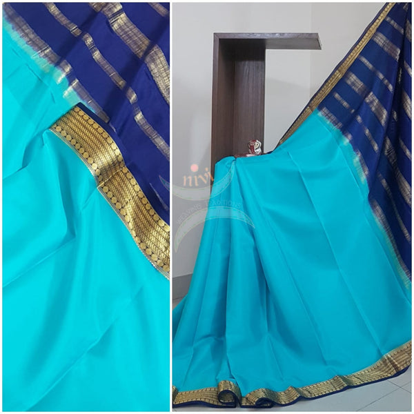 Blue with Navy blue 50 grams pure mysore silk crepe with traditional border and striped pallu. Saree comes with plain navy blue blouse matching pallu.