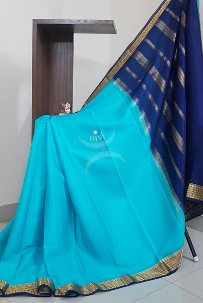 Blue with Navy blue 50 grams pure mysore silk crepe with traditional border and striped pallu. Saree comes with plain navy blue blouse matching pallu.