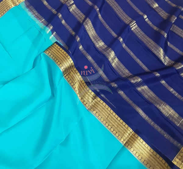 Blue with Navy blue 50 grams pure mysore silk crepe with traditional border and striped pallu. Saree comes with plain navy blue blouse matching pallu.