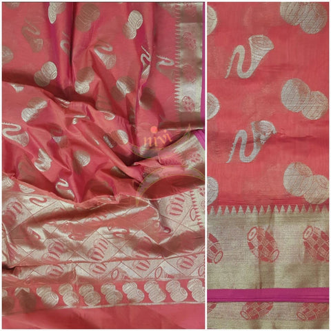 Peach short orange silk cotton benaras brocade with antique zari woven musical instrument motifs.