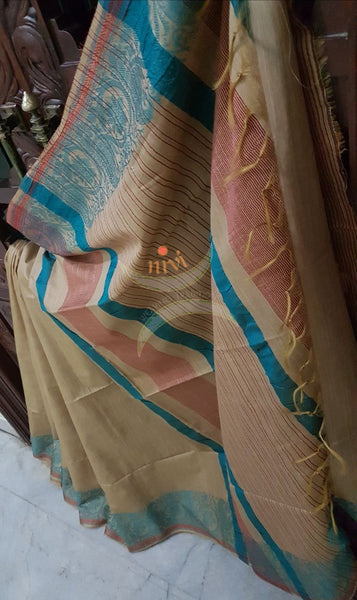Beige with blue handloom cotton saree with traditional paisley woven border and striped pallu.
