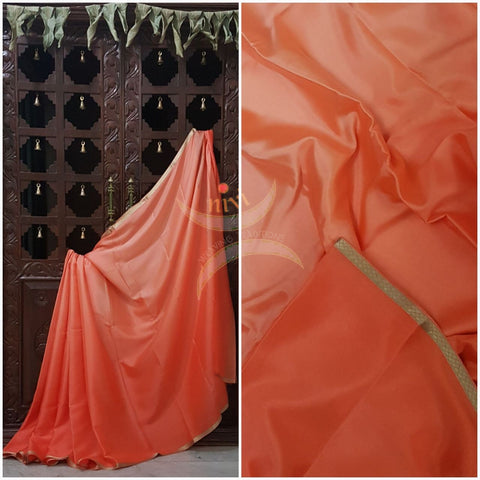 Peach 50 gms Two Tone waterproof pure Silk Crepe with a fine zari border. Saree comes with pure peach crepe blouse in darker tone.