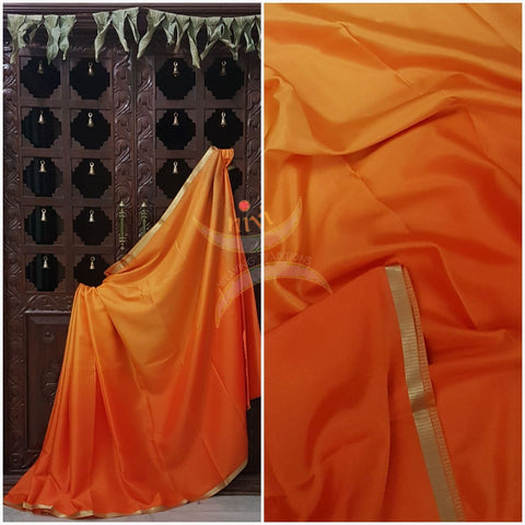 Yellow orange 50 gms Two Tone waterproof pure Silk Crepe with a fine zari border. Saree comes with orange crepe blouse in darker tone.