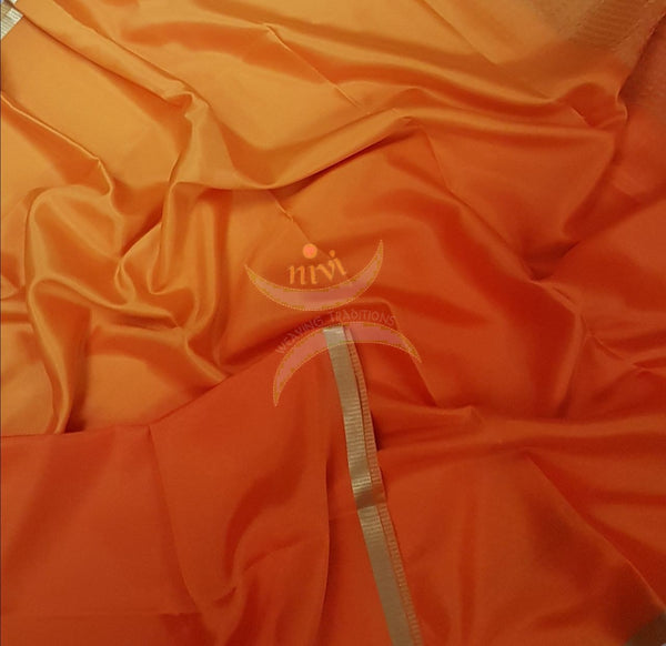 Yellow orange 50 gms Two Tone waterproof pure Silk Crepe with a fine zari border. Saree comes with orange crepe blouse in darker tone.