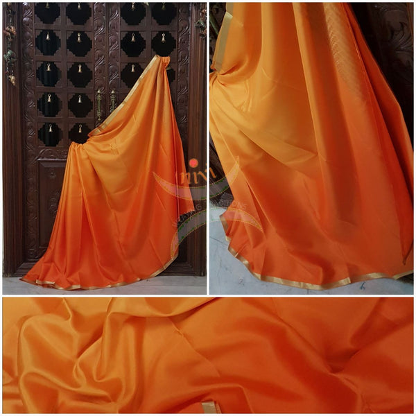 Yellow orange 50 gms Two Tone waterproof pure Silk Crepe with a fine zari border. Saree comes with orange crepe blouse in darker tone.