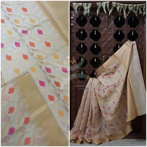 Off white silk cotton benaras brocade with floral booties all over the saree and tradition temple border and brocade pallu woven with antique zari.