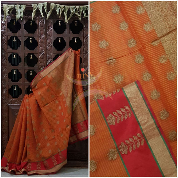 Orange Linen Cotton Benaras Brocade saree with floral motifs, contrast red border and antique zari weaving all over the saree .