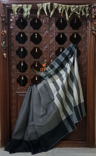 Grey cotton blended saree with contrasting black border and striped pallu.