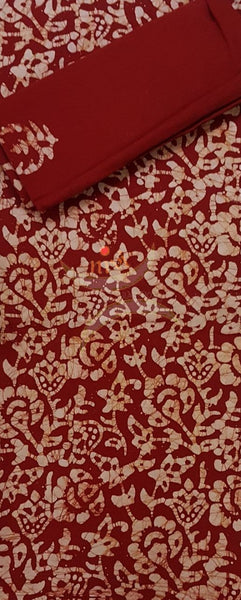 Red Batik printed three piece pure merserised cotton suit. Dress material is printed with abstract floral motif.