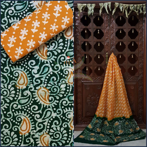 Bottle green with mustard Batik printed three piece pure merserised cotton suit.dress material is printed with abstract paisley and floral motif.
