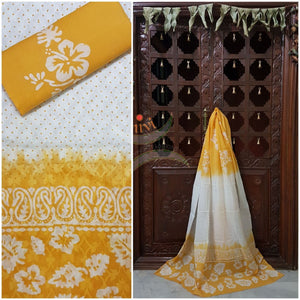 Off white with yellow batik three piece pure merserised cotton suit with self woven floral pattern all over.