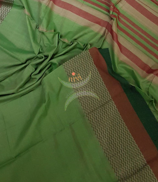 Pista green with red green Eco friendly natural dyed soft organic cotton with mercerised finish. The saree has thread woven traditional border and  striped pallu.