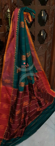 Green with maroon sico traditional South saree with peacock motif allover the saree, border and pallu.
