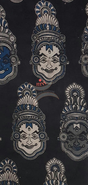 Black handwoven cotton kalamkari material with kathakali face motifs.