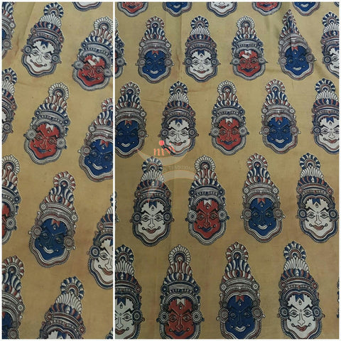 Yellow handwoven cotton kalamkari material with kathakali face motifs.
