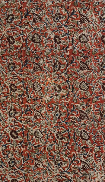 Red handwoven cotton kalamkari material with floral motifs.